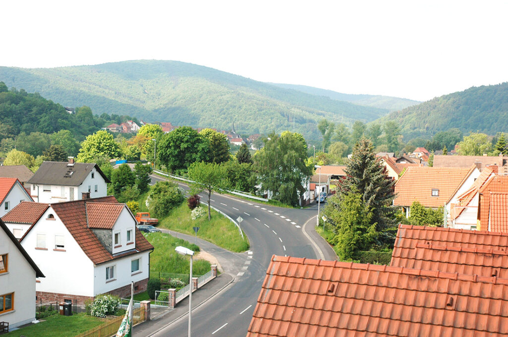 Landscape of Gemünden with a main road, lots of green space and forests in the distance